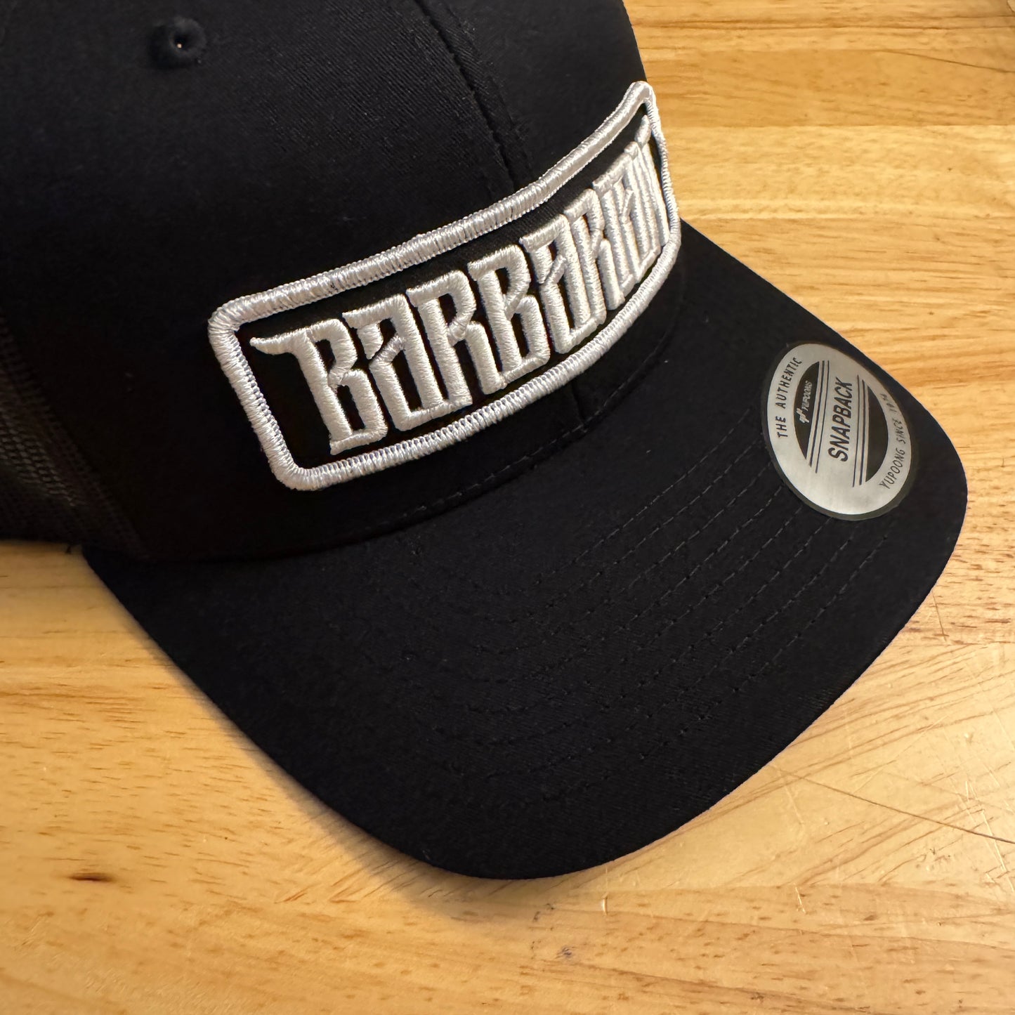 Yupoong Trucker Hat [Black] – White/Black Embroidered Patch