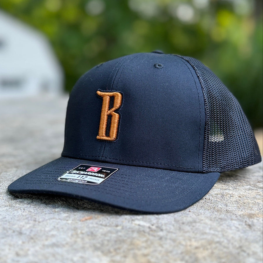 Barbarian "B" Trucker Hat [Richardson 112] – Black / Copper